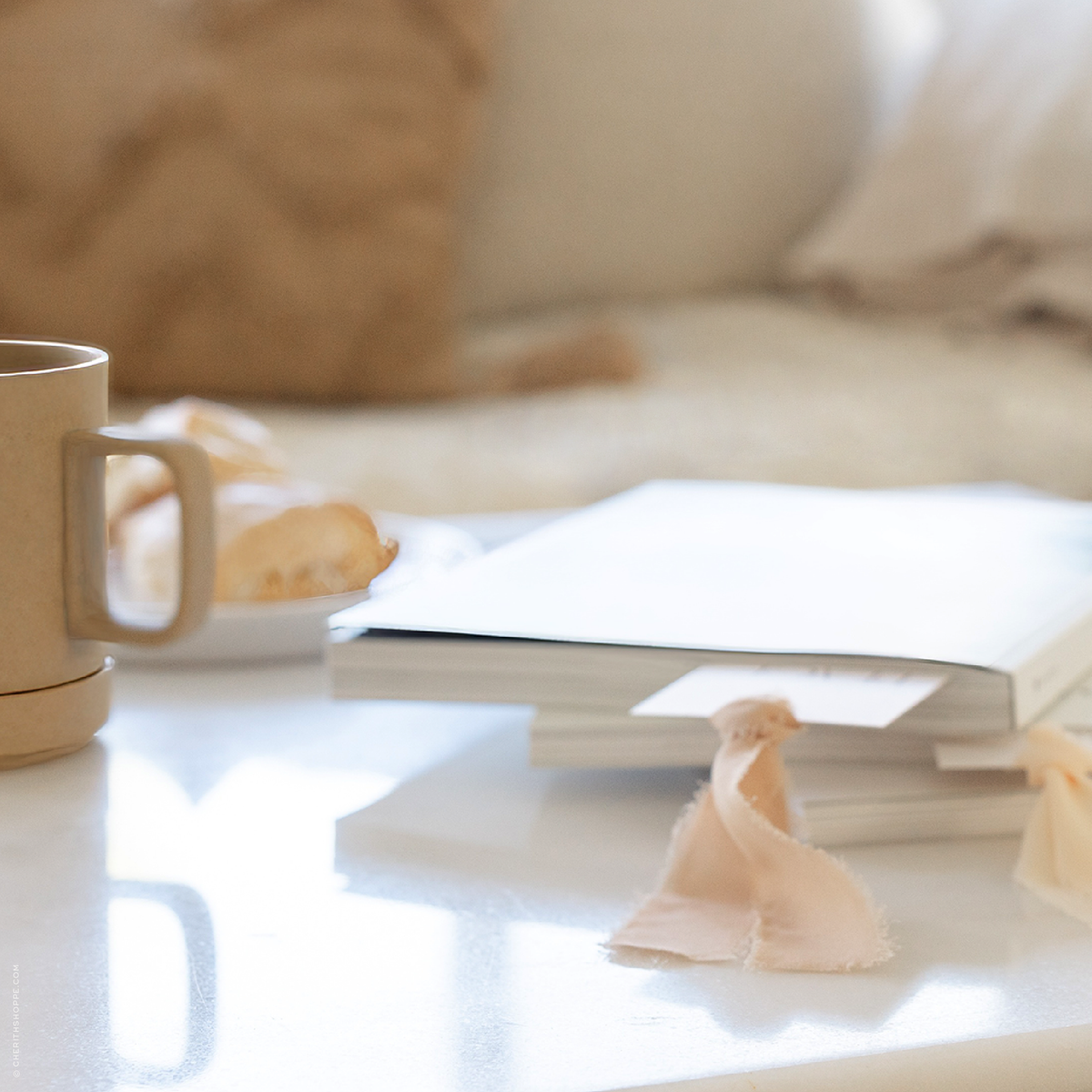 A moment of stillness with God.  Bibles with bookmarks tucked inside on a coffee table, in a peaceful home setting.