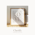 LOVE art print with 1 John 4:19 in a natural oak frame on a rattan console, Cherith Signature Collection