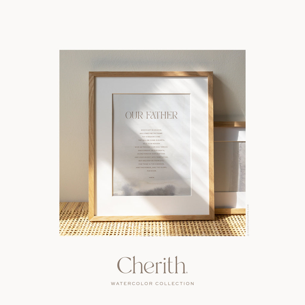 Our Father Prayer watercolor art print in a natural oak frame on a rattan console, by Cherith.