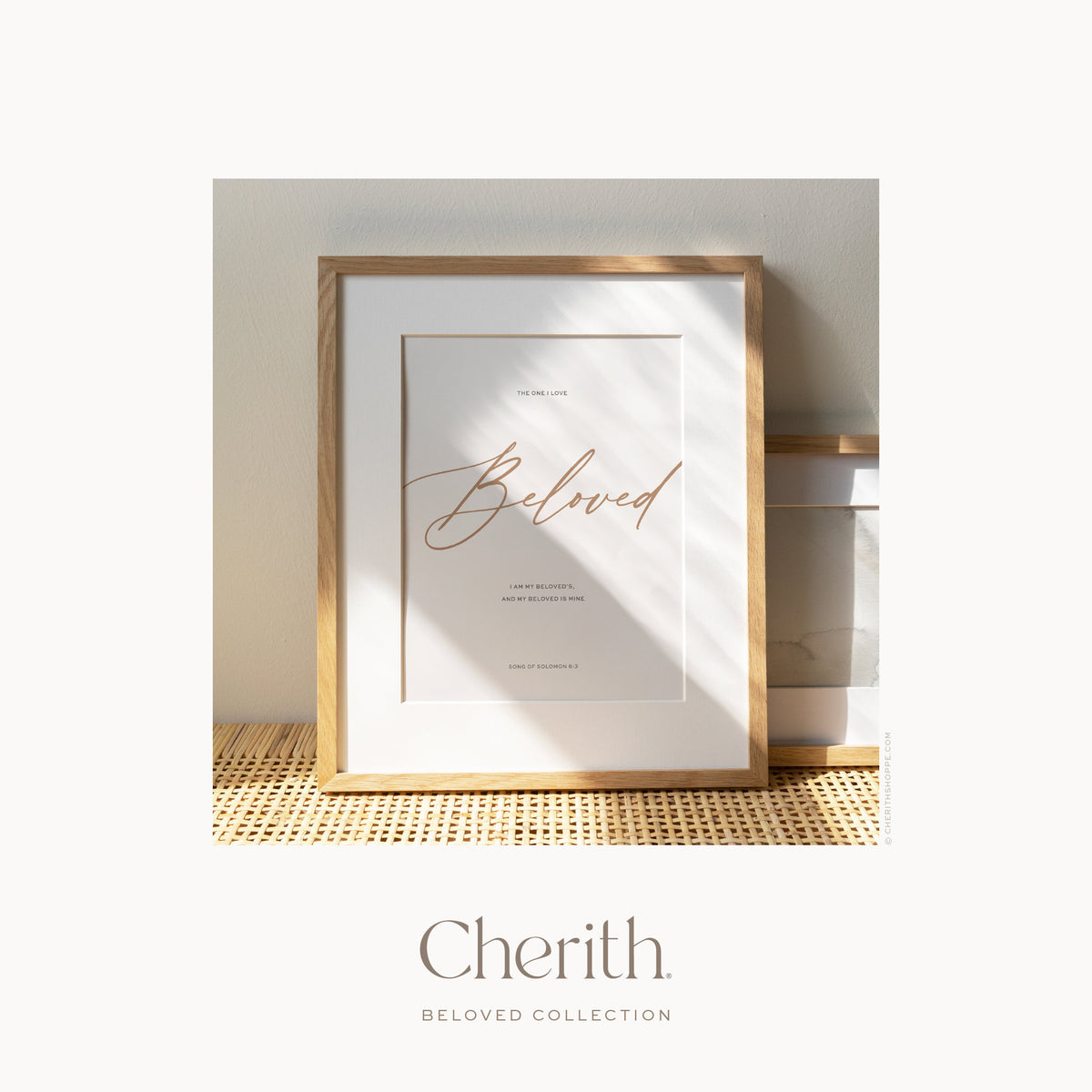 Beloved script art print with Song of Solomon 6:3 in an oak frame on a rattan console, by Cherith.