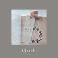 LOVE 1 John 4:11 bookmark with a ribbon resting on a Bible, by Cherith.