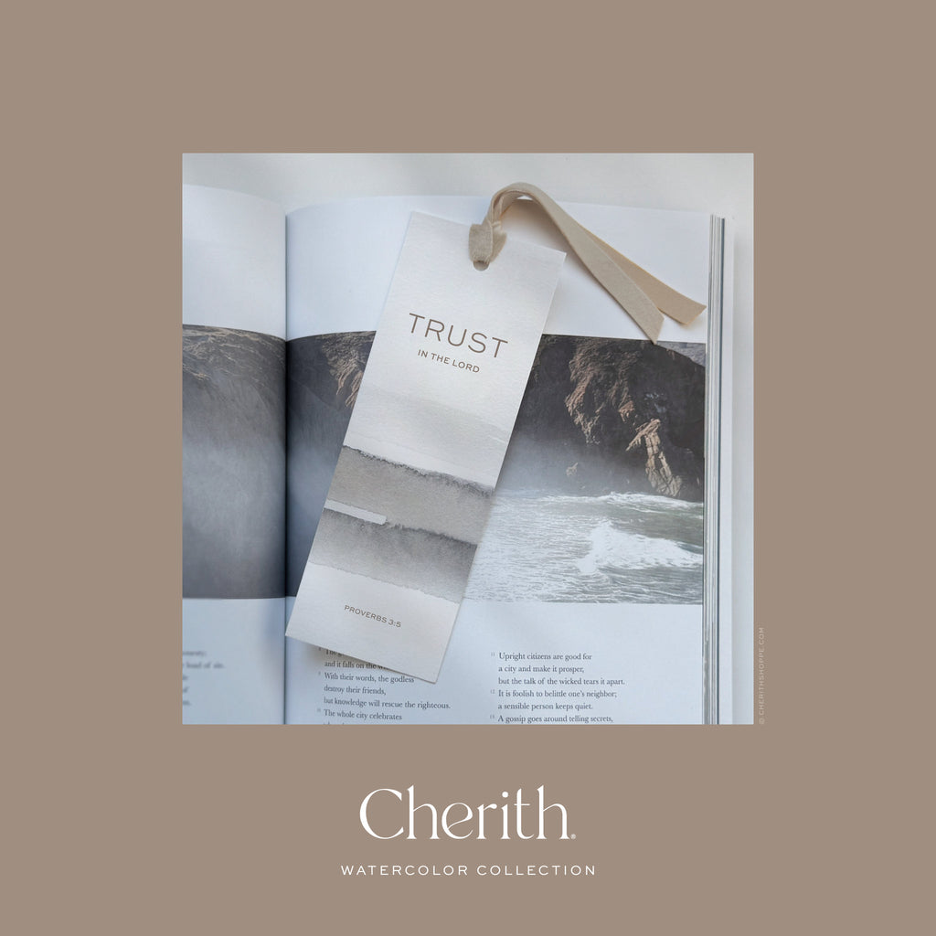 Trust in the Lord Proverbs 3:5 watercolor bookmark with a ribbon resting on a Bible, by Cherith.